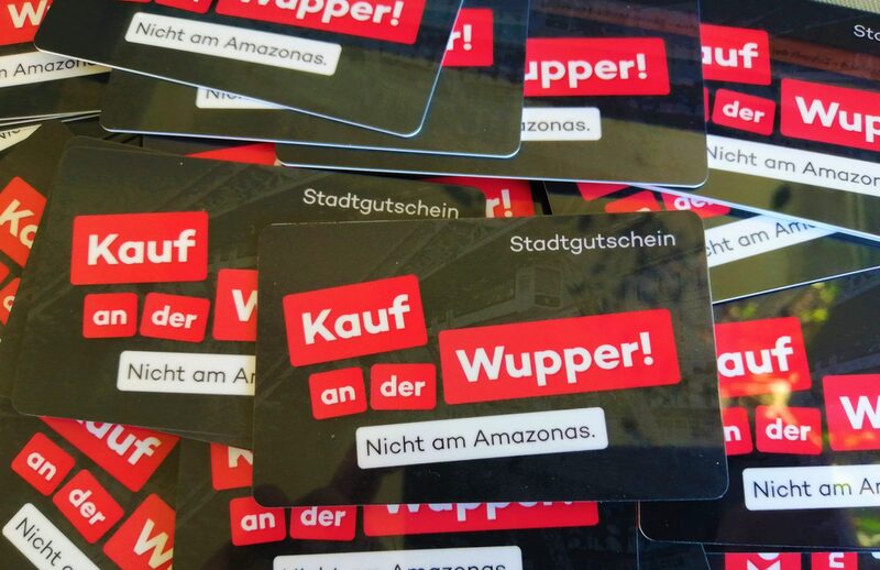 Die Stadtgutscheine der Online City Wuppertal mit dem Slogan "Kauf an der Wupper - nicht am Amazonas"